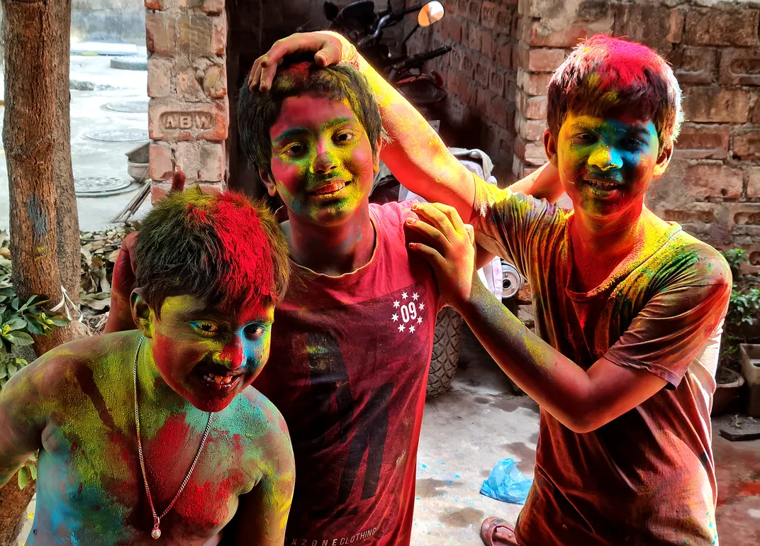 these three young pigmented pals are doused in red, yellow and blue powder