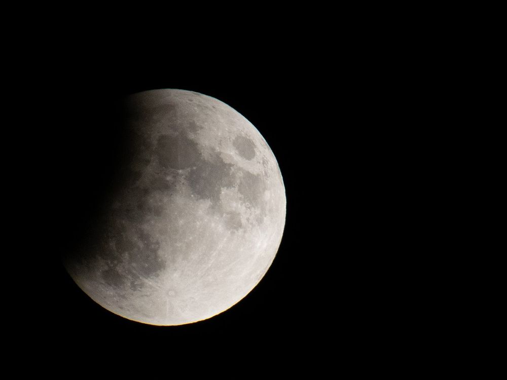 An image of the moon hidden partially by Earth's shadow.