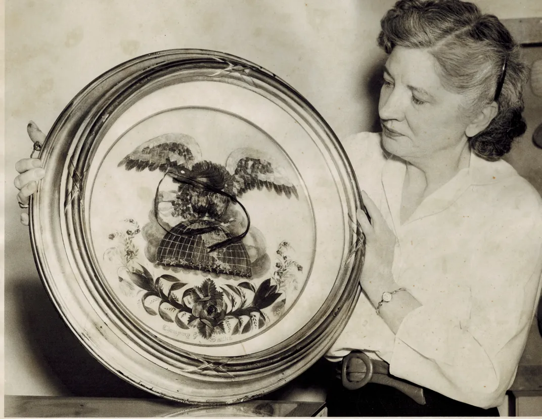 Former Onondaga Historical Association Director Caroline Wright holds the Hairy Eagle in this 1959 photo.