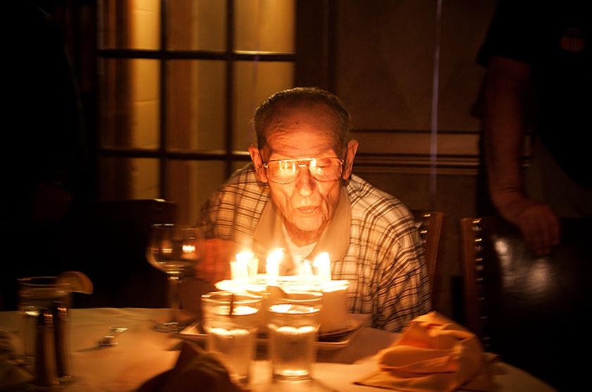 Grandpa blowing out candles on his 90th birthday. Smithsonian Photo
