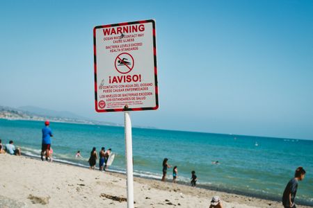 If a beach has signs that warn about contaminated water, it's probably not the best idea to swim.