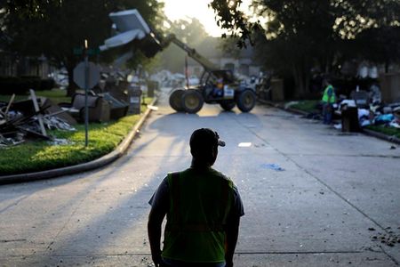 Crews clean up debris in a neighborhood flooded by Hurricane Harvey in Beaumont, Texas, Sept. 26, 2017