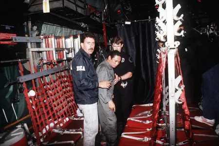 Manuel Noriega is escorted onto a U.S. Air Force aircraft by agents from the U.S. Drug Enforcement Agency (DEA) in 1990.