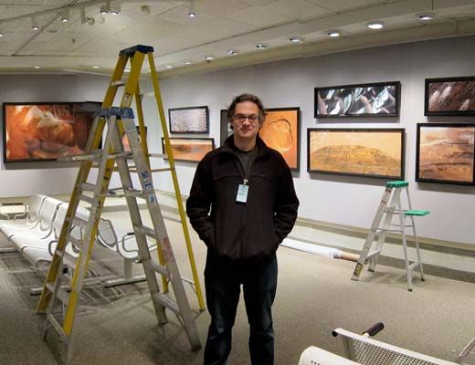 Author Michael Benson helps to set up the new National Air and Space Museum exhibition