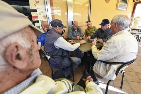 A group of old men playing cards in a bar in Acciaroli, southern Italy, in 2016. The town&nbsp;has a disproportionately high number of centenarians.