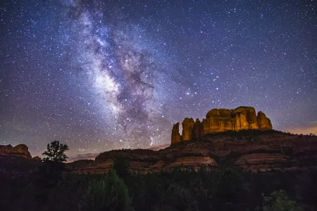 The Milky Way lights up the sky over Cathedral Rock in the Coconino National Forest in Sedona, Arizona.