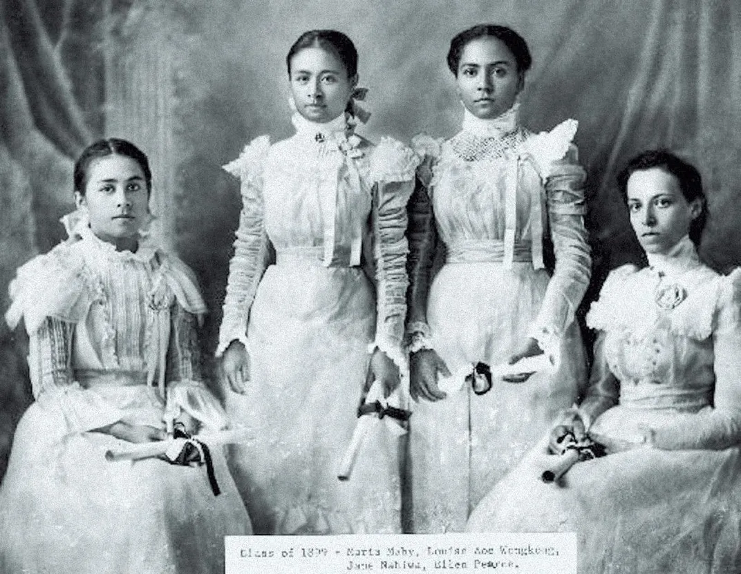 Hawaiian women in formal, westernized white dresses