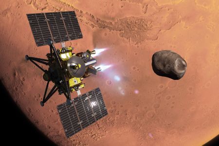 A digital art illustration of the gold and black spacecraft firing its white thrusters to maneuver near a dark, rocky moon, with the reddish surface of Mars visible in the background.