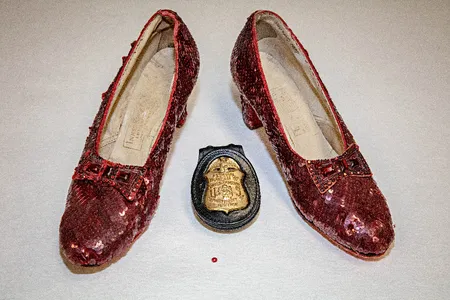 A Minnesota man has been indicted in connection with the 2005 theft of a pair of Judy Garland's ruby slippers, seen here when they were recovered in 2018, along with the single red sequin that was left at the scene of the crime.
