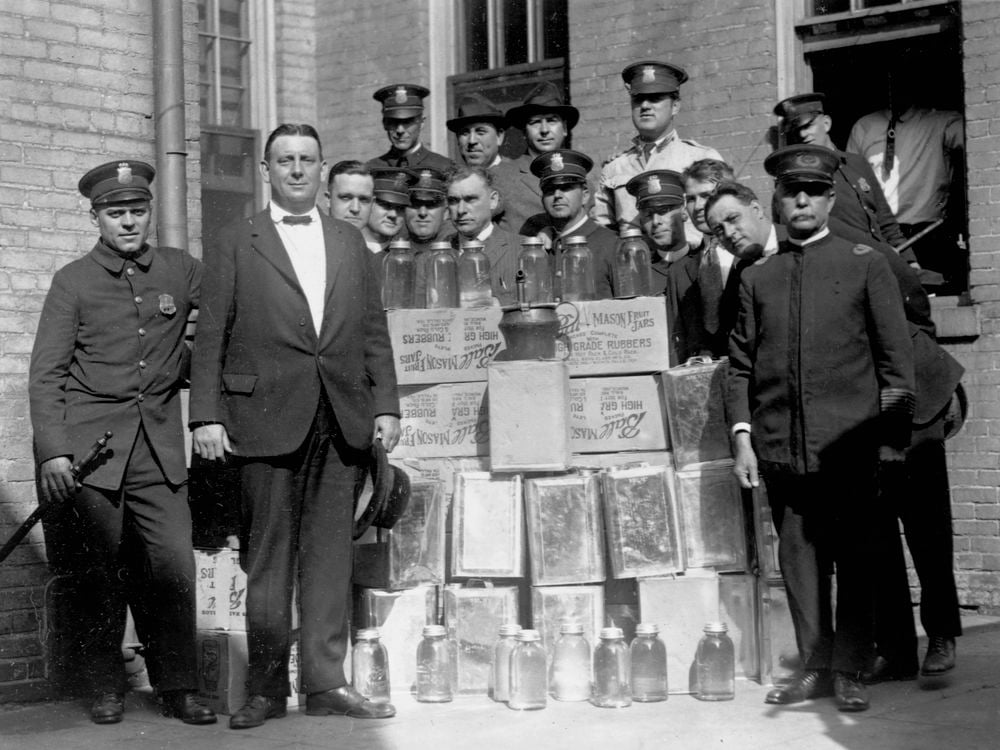 Police Officers With Confiscated Moonshine