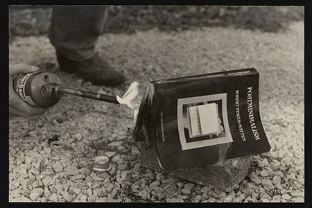 Lorna Truck and Tim Benson. Photograph documenting burning of Robert Pincus-Witten's book Postminimalism (1977) at the request of artist Buster Cleveland as part of the 1979 Des Moines Festival of the Avant-Garde, circa 1979. Fred Truck papers, 1965-2019. Archives of American Art, Smithsonian Institution.