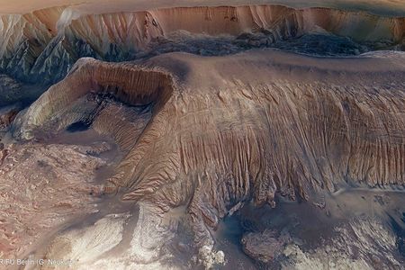 This amazingly detailed image from ESA's Mars Express orbiter shows the Hebes Chasma mesa:

The details of the central mesa inside Hebes Chasma are seen in close-up detail in this perspective view. A horseshoe-shaped chunk has been taken out of one side of the mound (left in this image); the material has slumped down onto the floor of the valley below. A dark patch appears to pool like spilt ink across the debris. It is most likely loose material that has slid down the walls from an intermediate layer. Melted ice could have played a role by weakening the rocks to create its flow-like appearance.

Along the side of the mound fine horizontal layering is seen. The layers likely comprise a mix of wind-blown dust and ancient lake sediments, along with remnants of the older plateau.

Image: ESA/DLR/FU Berlin (G. Neukum)