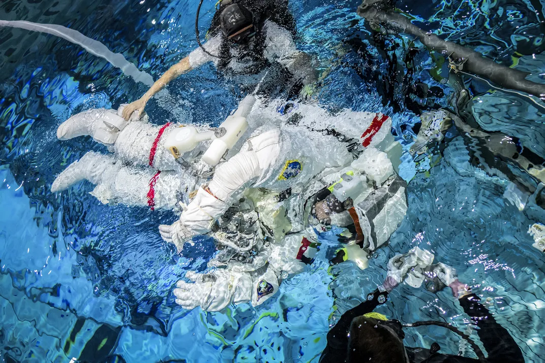 11 - Support divers assist UAE astronaut Sultan Al Neyadi at the NASA Neutral Buoyancy Laboratory, in Houston. Astronauts train in this 6.2-million-gallon diving tank in preparation for their mission to the International Space Station.