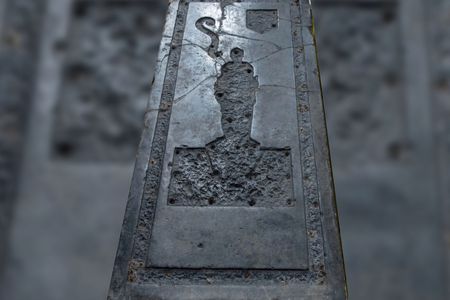 The black "marble" tombstone is made of limestone that likely came from Belgium.