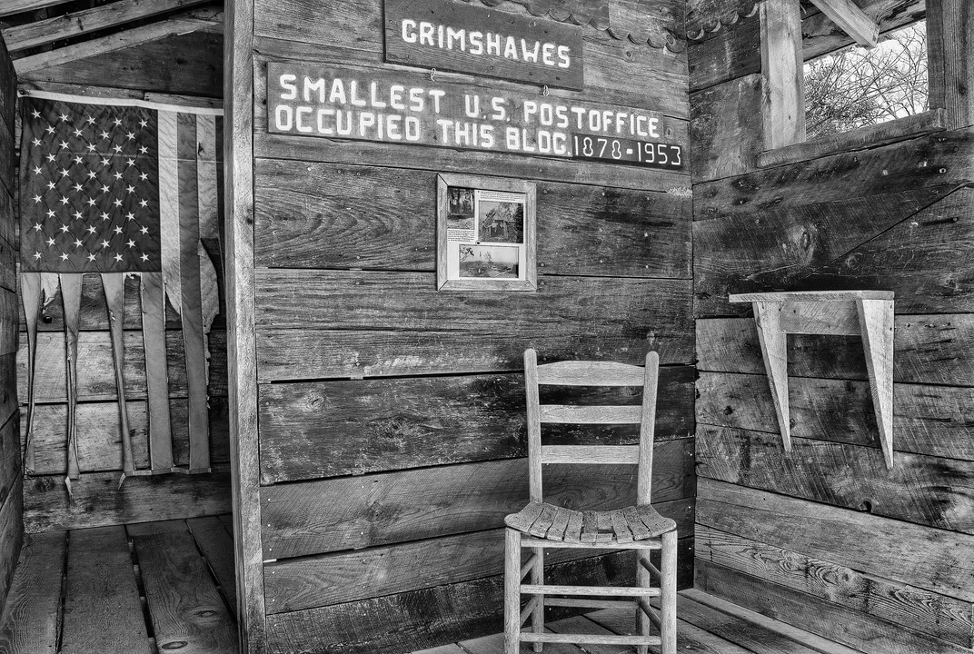 Black and white photo of a shack post office