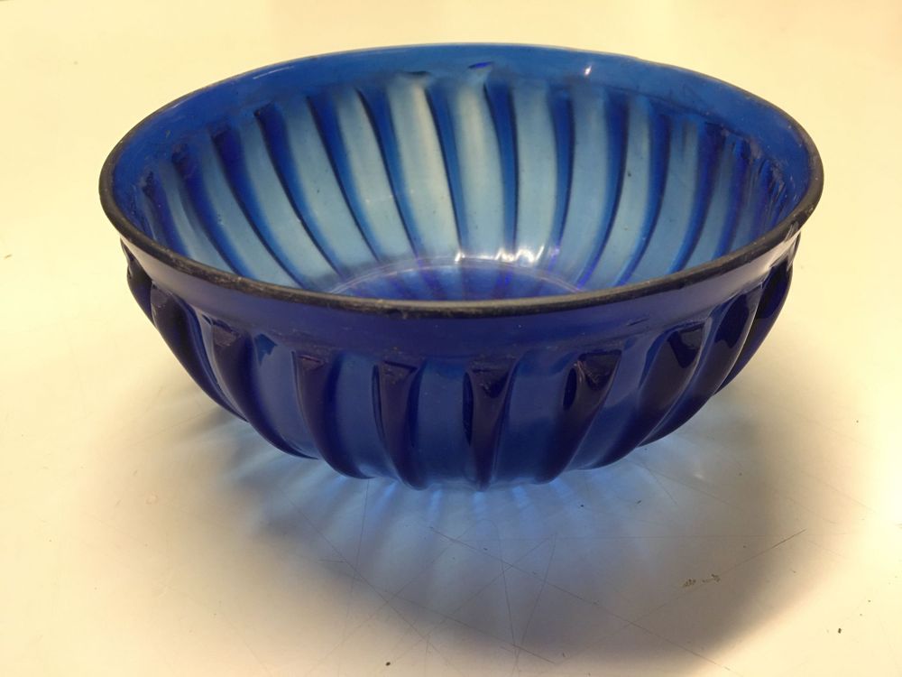 A close up shot of the blue glass bowl on a table