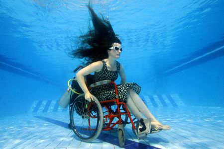 Artist Sue Austin scopes out a pool in her underwater wheel chair.