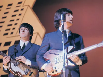 Paul McCartney and John Lennon performing with the Beatles in 1965