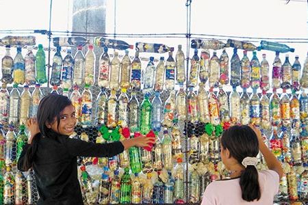 Peace Corps volunteer Laura Kutner rallied the community to stuff plastic bottles with trash. In all, the Guatemalan students turned 8,000 bottles into building materials.