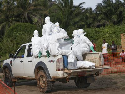 Health workers burying an Ebola victim in Liberia