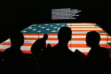 Invitees to the museum’s grand reopening in 2008 admire the newly restored flag.