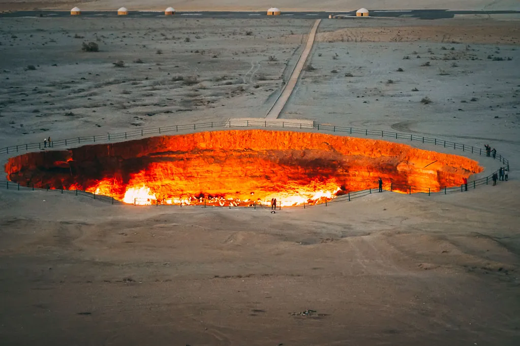 Giant crater pit filled with hot molten earth in middle of desert