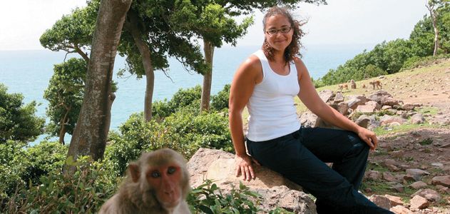 biologist Laurie Santos (with a research subject on Cayo Santiago)