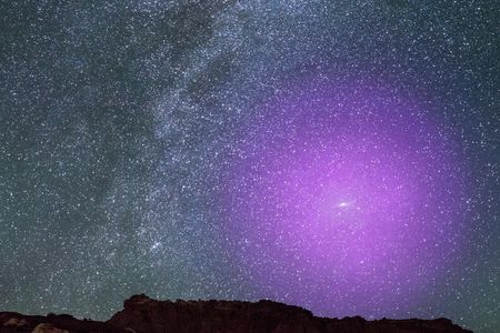 This illustration depicts what Andromeda's gaseous halo might look like if it were visible to humans on Earth. At three times the size of the Big Dipper, the halo would be "easily the biggest feature on the nighttime sky," per the NASA statement.