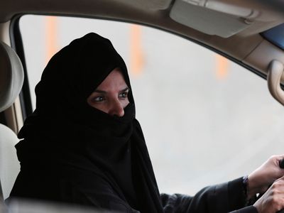 In this Saturday March 29, 2014 file photo, a woman drives a car on a highway in Riyadh, Saudi Arabia, as part of a campaign to defy Saudi Arabia's ban on women driving. Saudi Arabia authorities announced Tuesday Sept. 26, 2017, that women will be allowed to drive for the first time in the ultra-conservative kingdom from next summer, fulfilling a key demand of women's rights activists who faced detention for defying the ban.