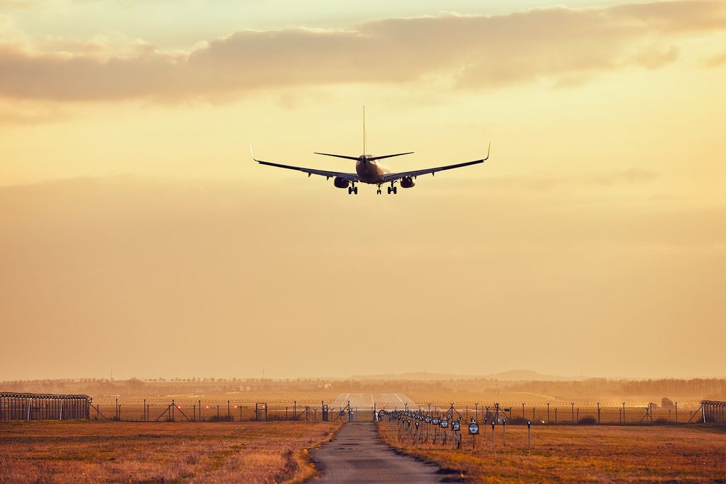 Airplane flying into sunset
