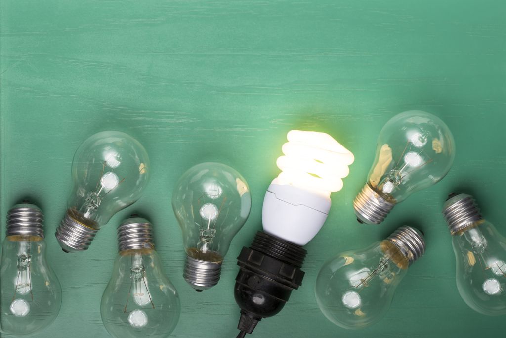 Incandescent light bulbs with one energy-efficient lightbulb glowing