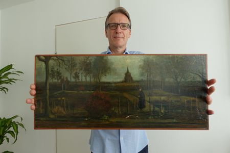 Arthur Brand poses with The Parsonage Garden at Nuenen in Spring, painted by Vincent van Gogh in 1884.