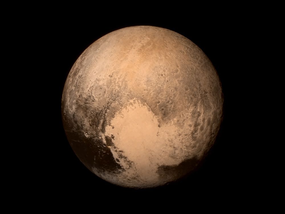 A photograph of Pluto shows patches of beige, black and grey areas mottled with spherical shapes and many other unidentified features.