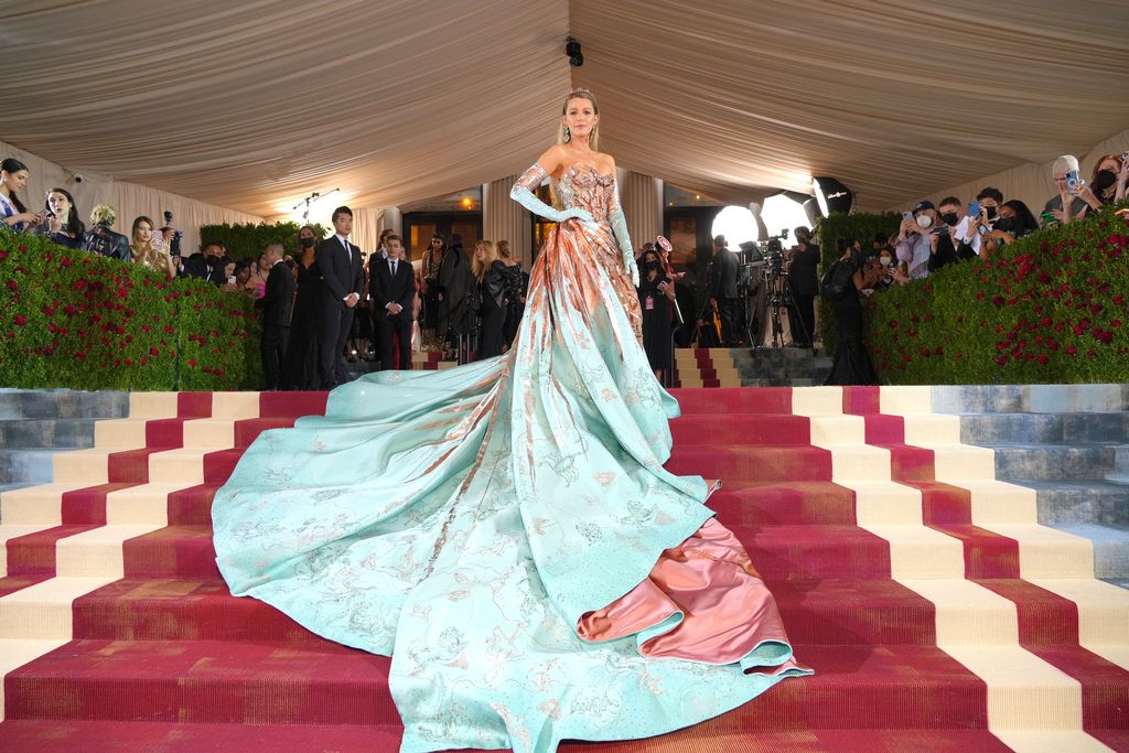Actress Blake Lively wore a gown whose copper bow unfurled into a blue-green train.