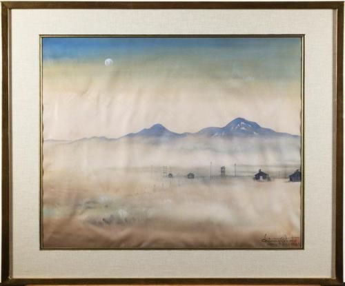 Watercolor scene of pale blue mountains with a full moon against a dusty blue sky.  The dusty brown and tan terrain has black buildings and a fence in the distance.  The piece is matte linen with a wooden frame with gold accents.