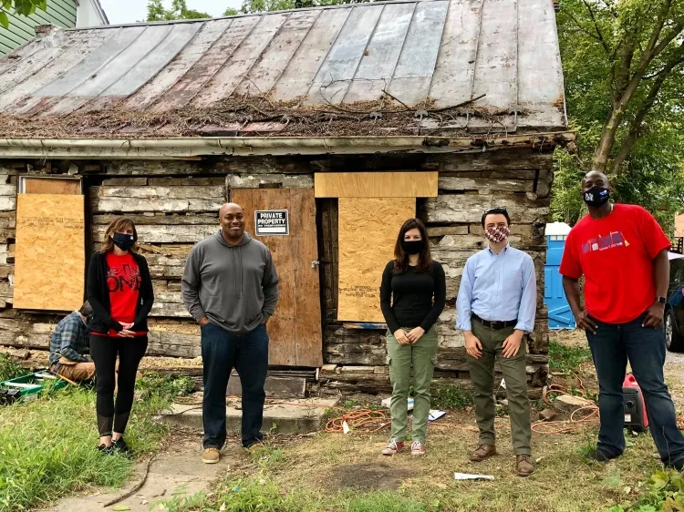 Archaeological team in front of cabin