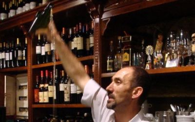 In northern Spain, pouring apple cider from bottle to glass is a sport requiring dexterity and skill, as demonstrated by this barman in La Calzada, Asturias.