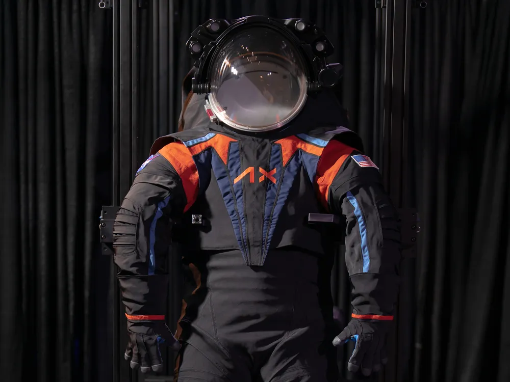 Dark grey space suit against black backdrop