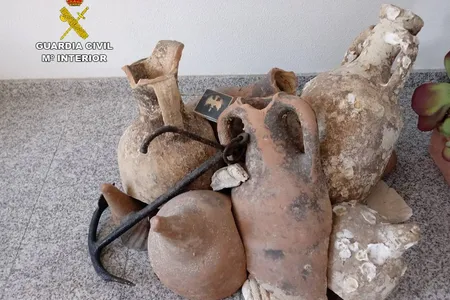 Police discovered a total of 13 Roman amphorae and an 18th-century anchor inside a frozen seafood shop in Alicante, Spain.