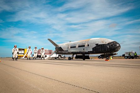 Pictures? No problem. But don’t expect much information. A crew tends to the X-37B after it landed at Vandenberg Air Force Base in October 2014, after 674 days in orbit. 