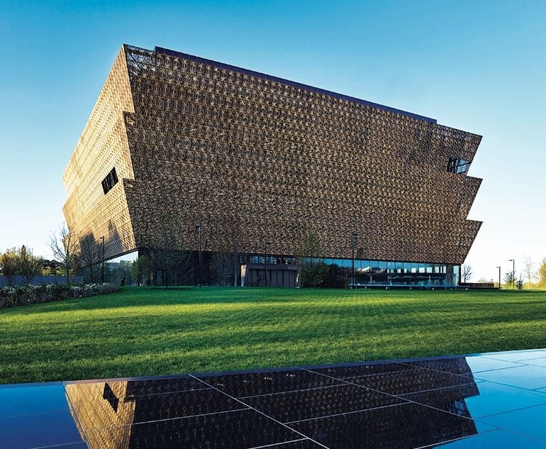 Wrapped in an ornamental bronze latticework, the angular lines of the Museum rise in stark contrast to the rich green landscape.