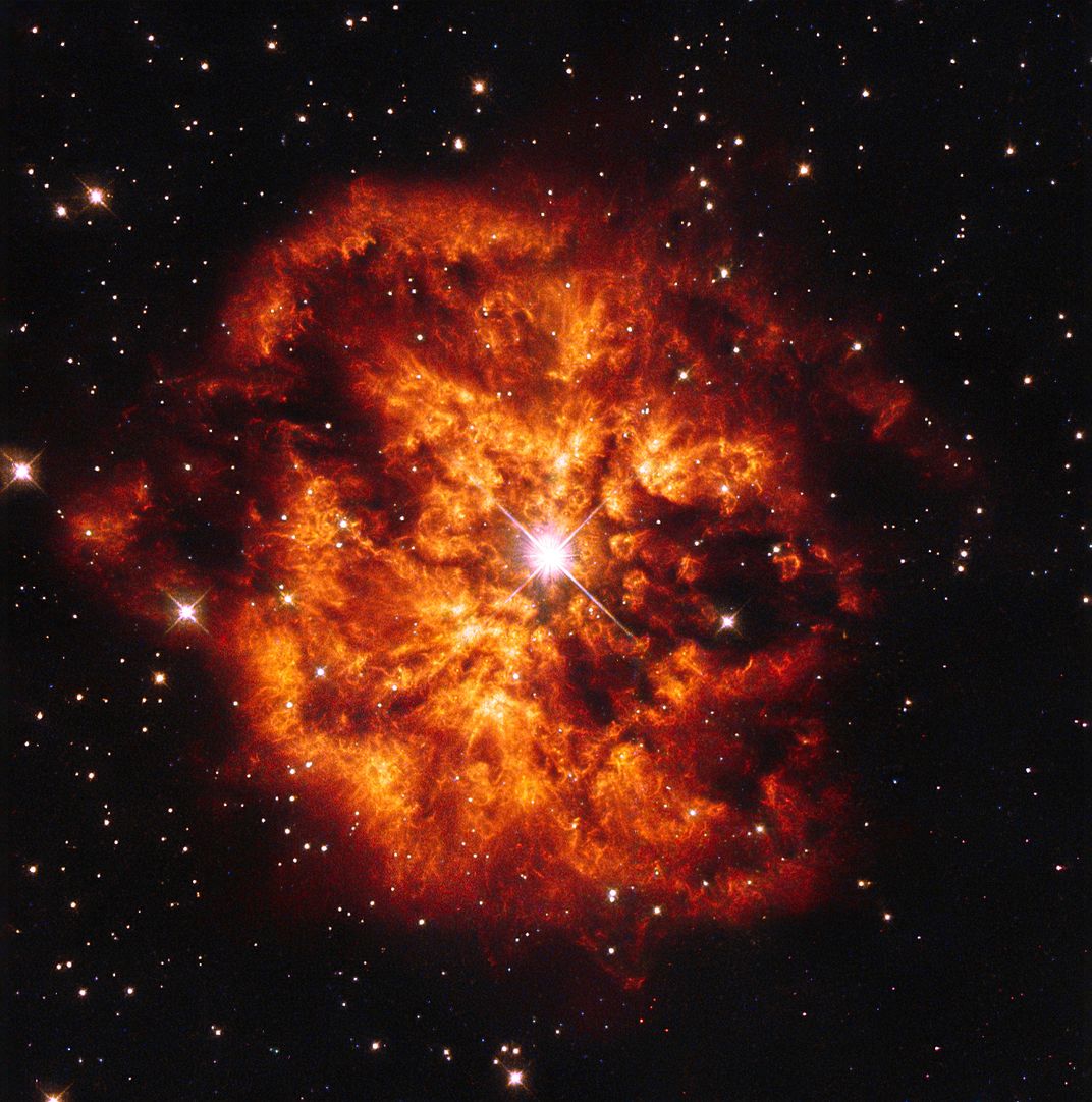 Fiery red and orange nebula against a black backdrop