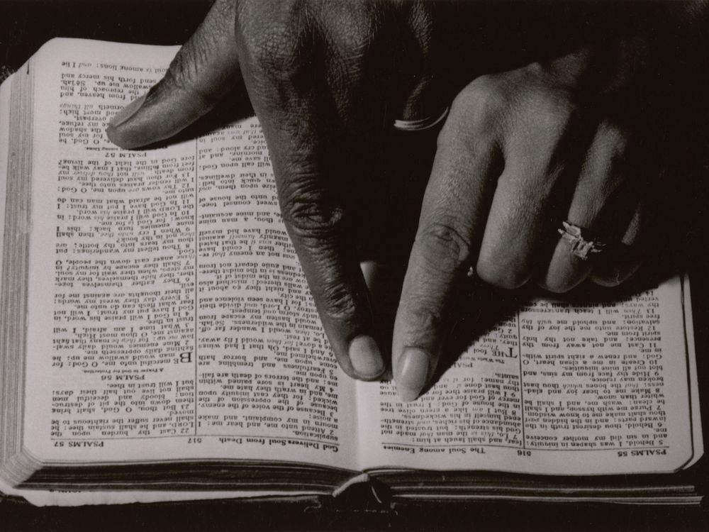 Two hands pointing to a Bible passage, ca. 1968