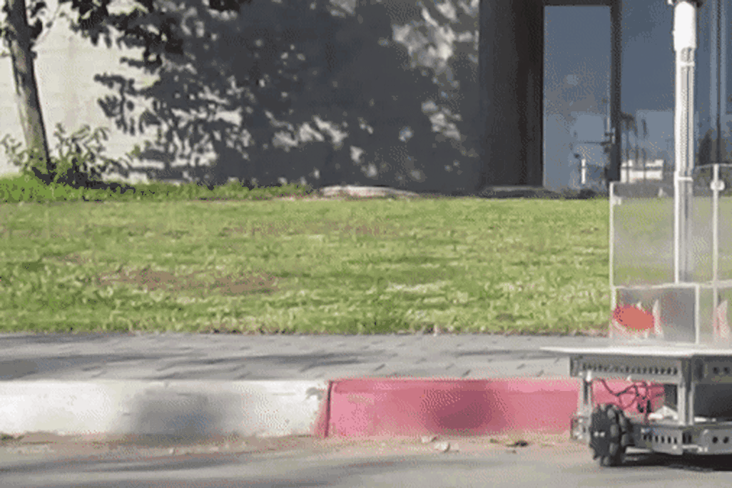 A gif image of a fish navigating a tank on wheels