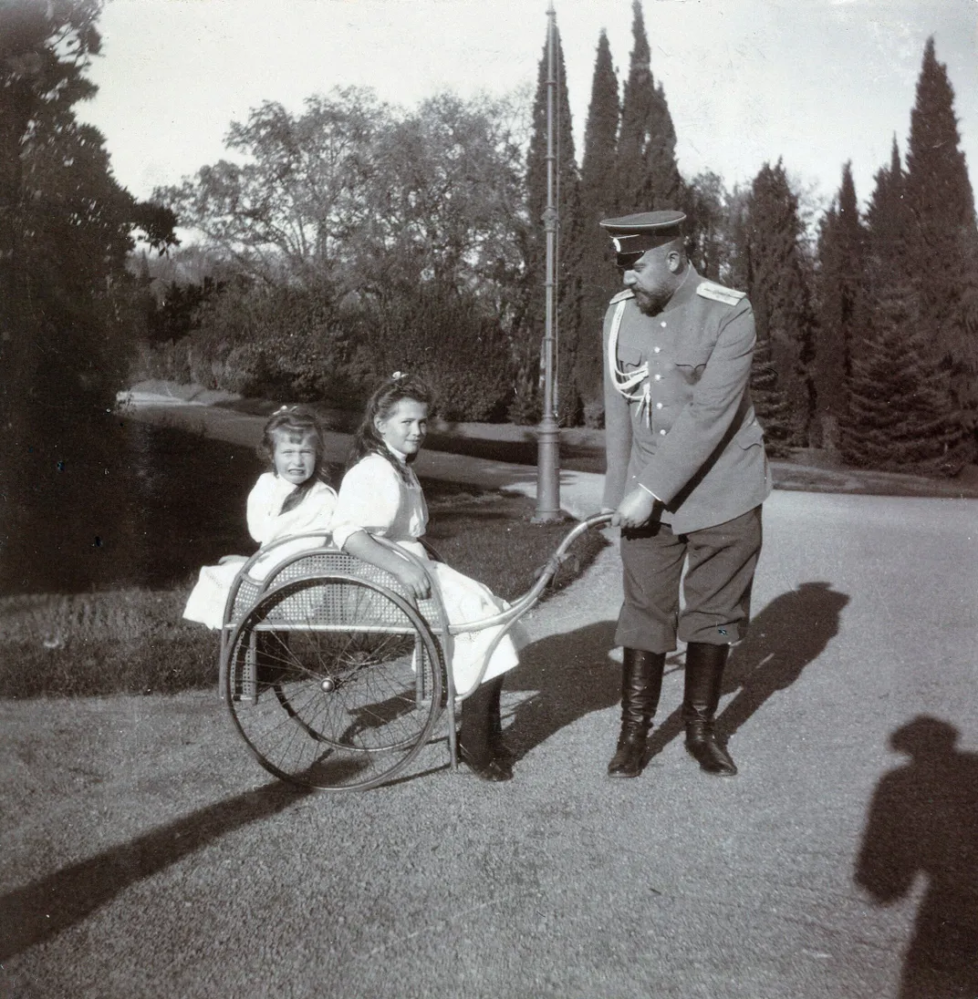 Anastasia (left) and Maria with court physician Eugene Botkin, who was executed alongside the imperial family in 1918