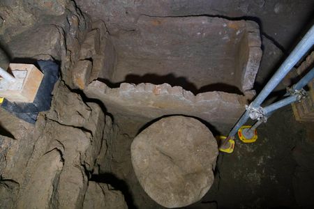 A 55-inch wide sarcophagus and what appears to be an altar are seen in an underground chamber at the ancient Roman Forum.