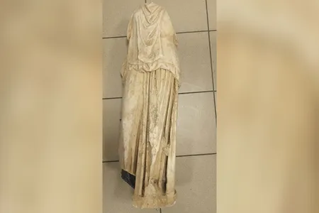 The recently discovered statue is missing its arms and head.