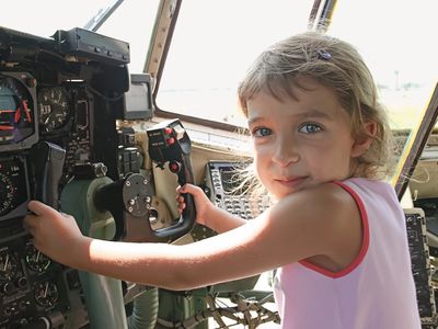 The author’s daughter, spellbound by a Hercules C-130, had little interest in the B-2 bomber that was entertaining an airshow crowd at the moment the photo was snapped.