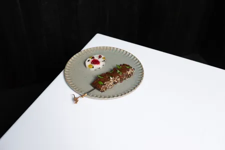 Roo Satay, a dish at Attica, in Melbourne, featuring a skewer of grilled red kangaroo and rice studded with native fruits and wattleseeds, which were traditionally ground into flour for bread.