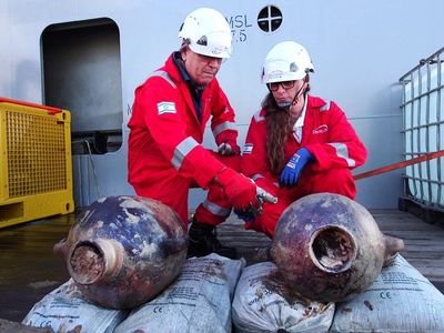 Jacob Sharvit and Karnit Bahartan examine two amphorae recovered from the world&#39;s oldest-known deep-sea wreck.